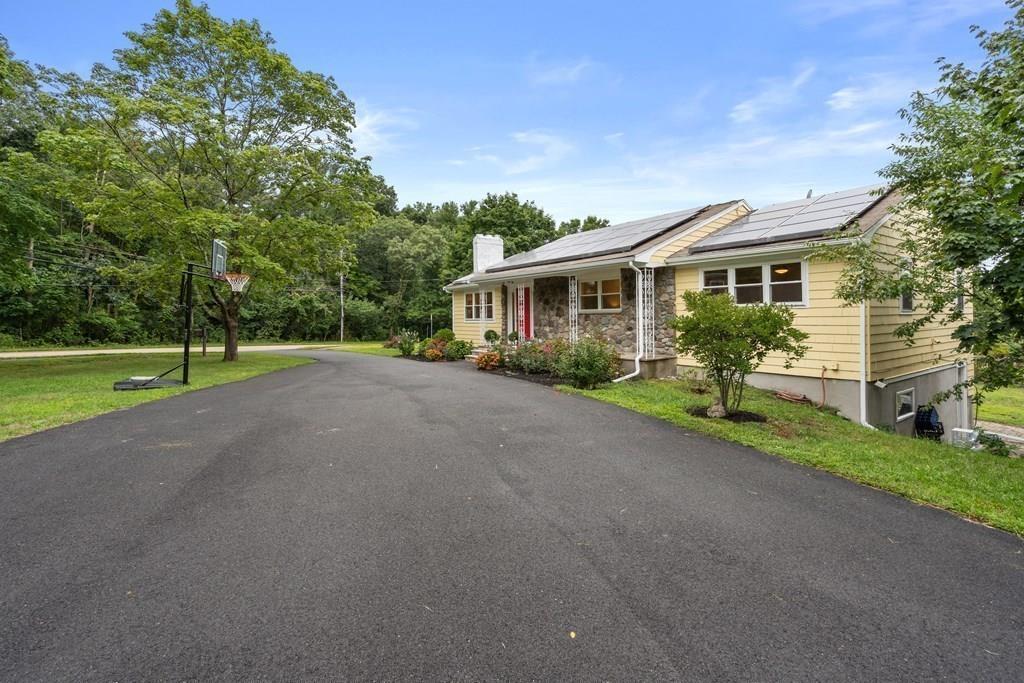 15 Pecunit Street Canton, MA 02021 - Photo 22 of 22 a view of a house with a yard and potted plants