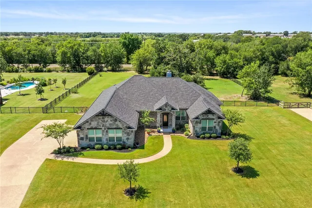 a view of a house with pool and a yard