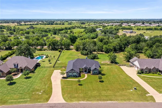 an aerial view of a house with yard swimming pool and outdoor seating