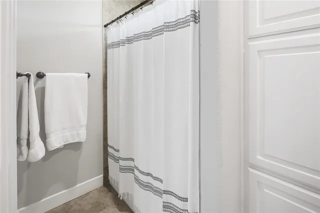 a bathroom with a shower and a sink