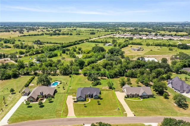 an aerial view of a residential houses with outdoor space