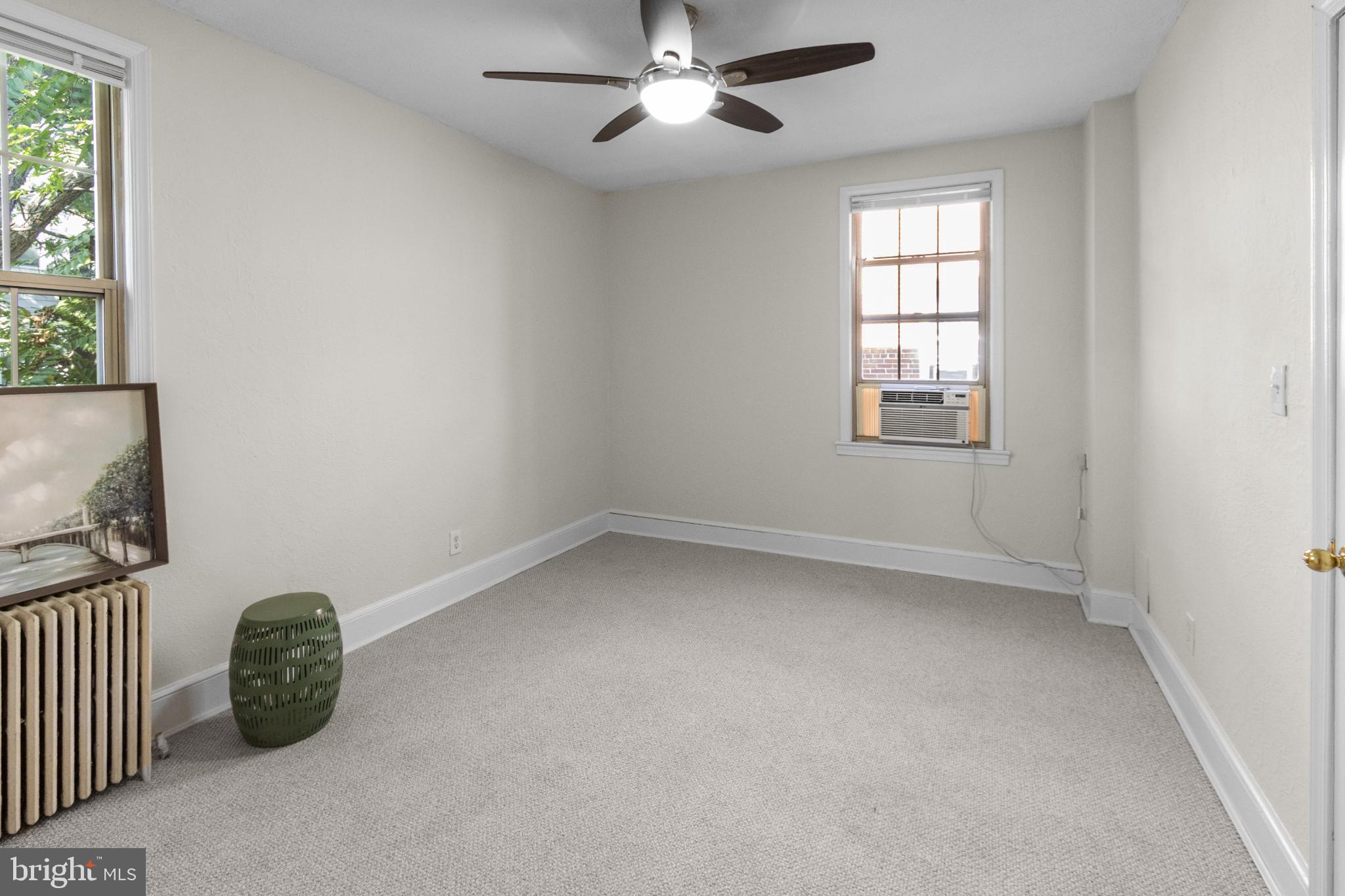 1441 Euclid Street Northwest, Unit 207 Washington, DC 20009 - Photo 17 of 23 an empty room with windows and fan