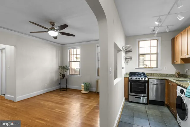 a view of a kitchen with a sink dishwasher and wooden floor