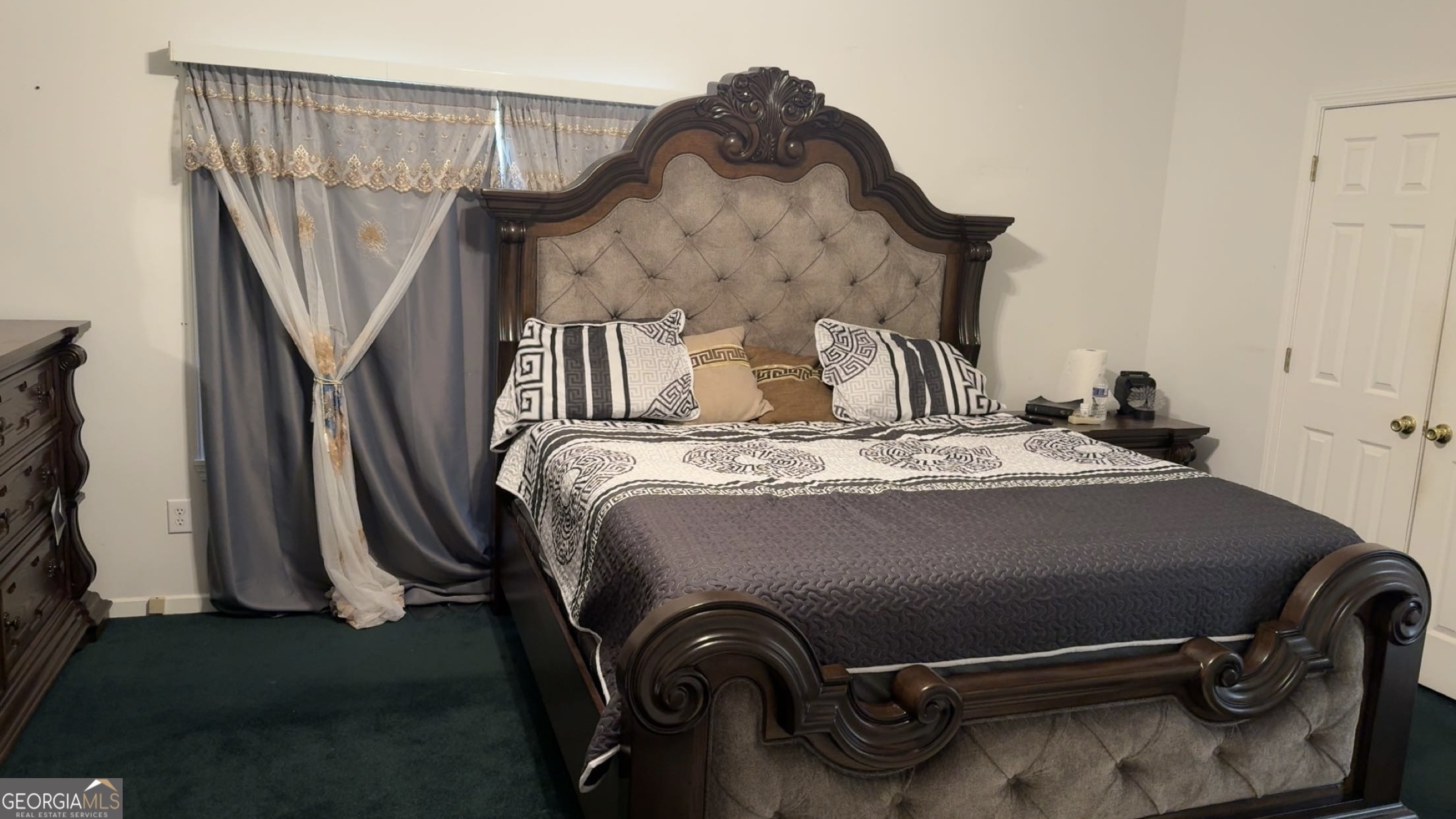 621 Highway 22 Sparta, GA 31087 - Photo 11 of 36 a bed sitting in a bedroom next to a window