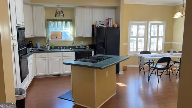 a kitchen with a stove and a refrigerator