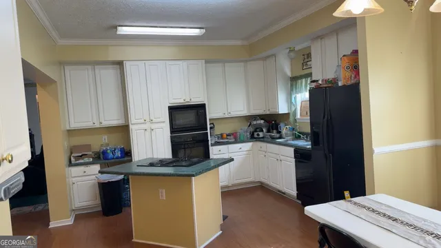 a view of a hallway view with wooden floor and furniture