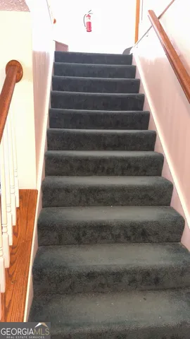 a view of entryway with wooden floor and door