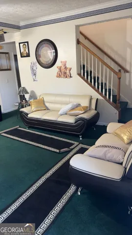 a living room with chairs and a table