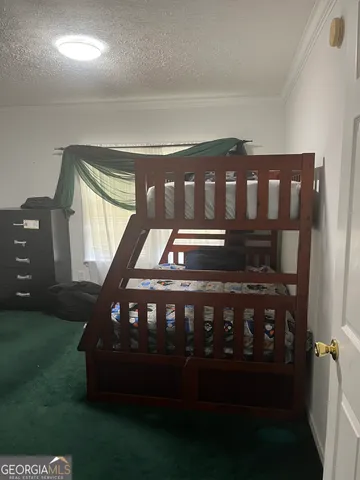 a bed room with a bed and a television