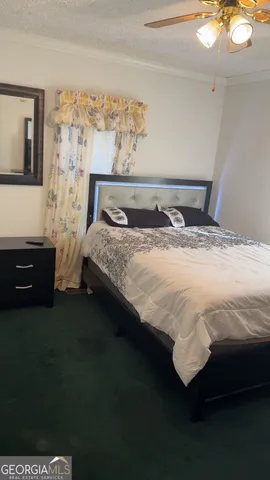 a bed sitting in a bedroom next to a window