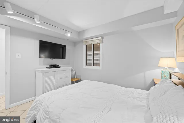 a bedroom with a bed and painting on the wall