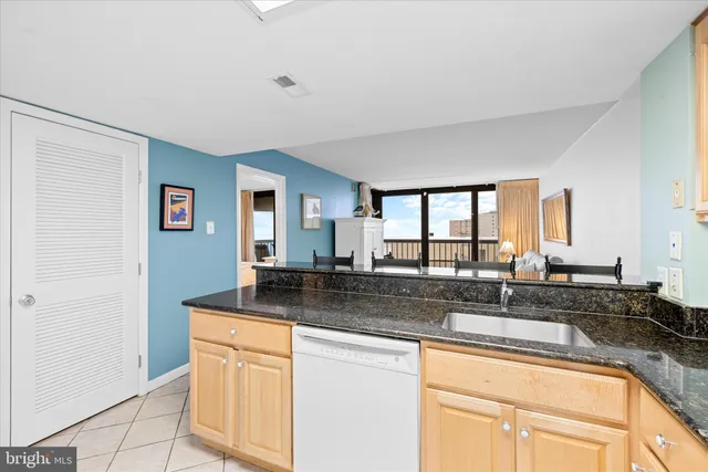 a spacious bedroom with a bed a table and windows