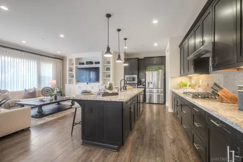 a large kitchen with kitchen island a large island in it