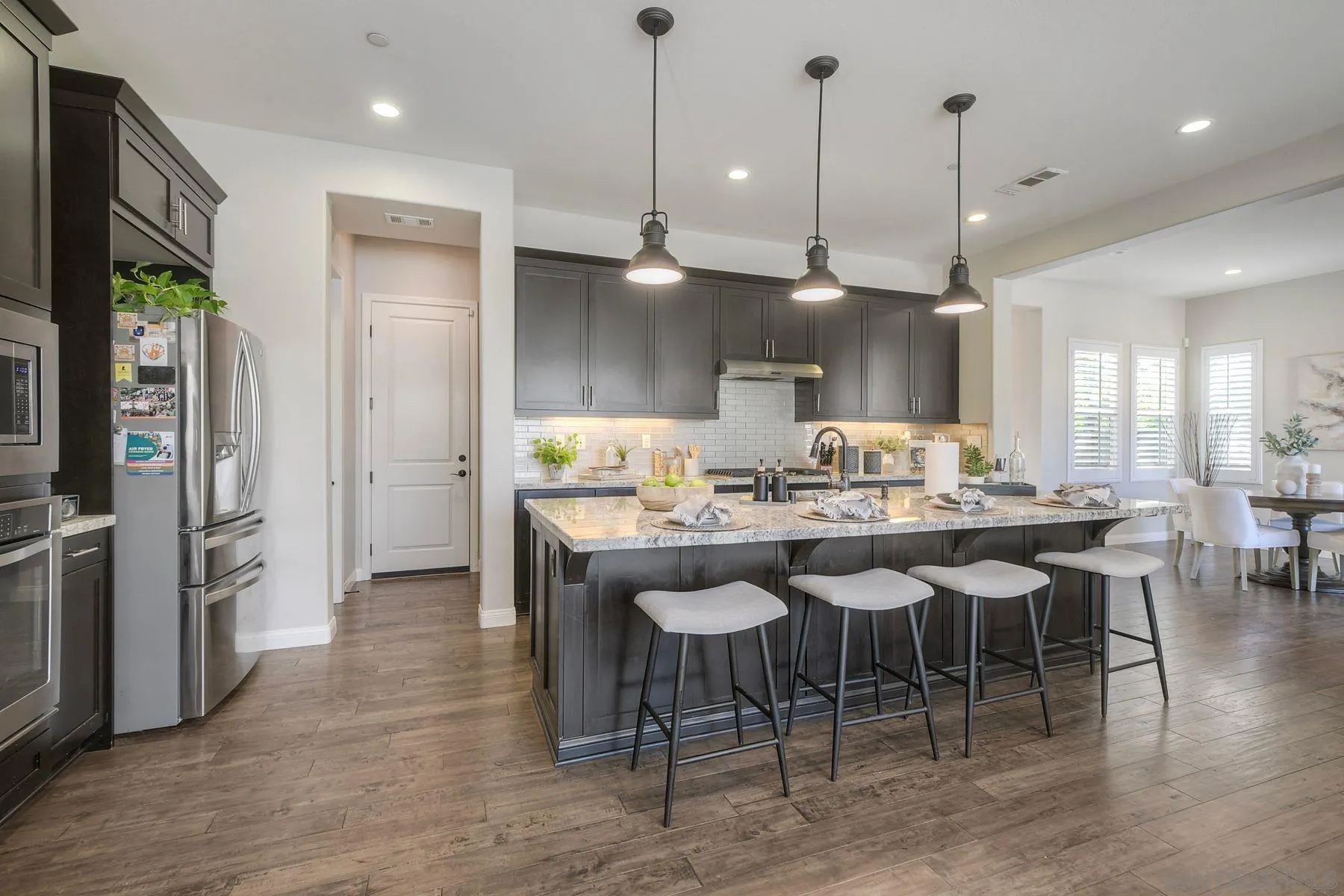 16482 Edgehill Road San Diego, CA 92127 - Photo 13 of 35 a large kitchen with a table and chairs