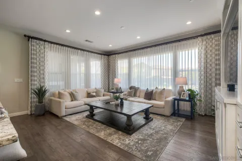 a living room with furniture and large windows