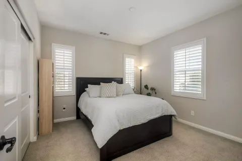 a bedroom with a bed and window