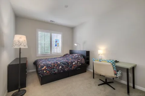 a bedroom with a bed and a table in it