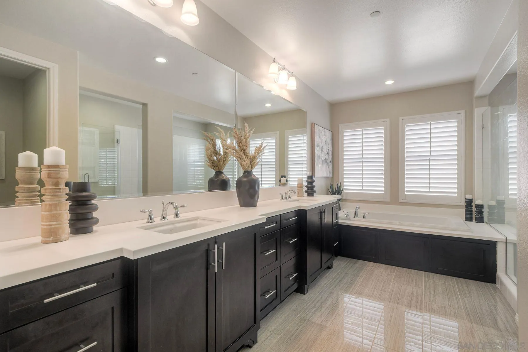 16482 Edgehill Road San Diego, CA 92127 - Photo 30 of 35 a spacious bathroom with a double vanity sink large mirror and a bathtub