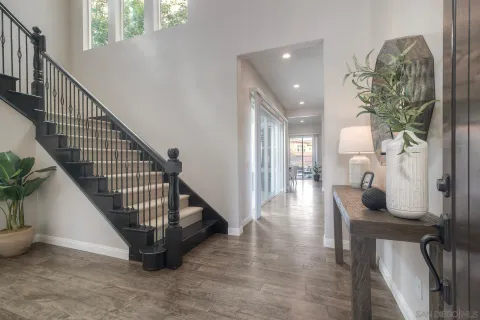 a view of entryway and hall with wooden floor