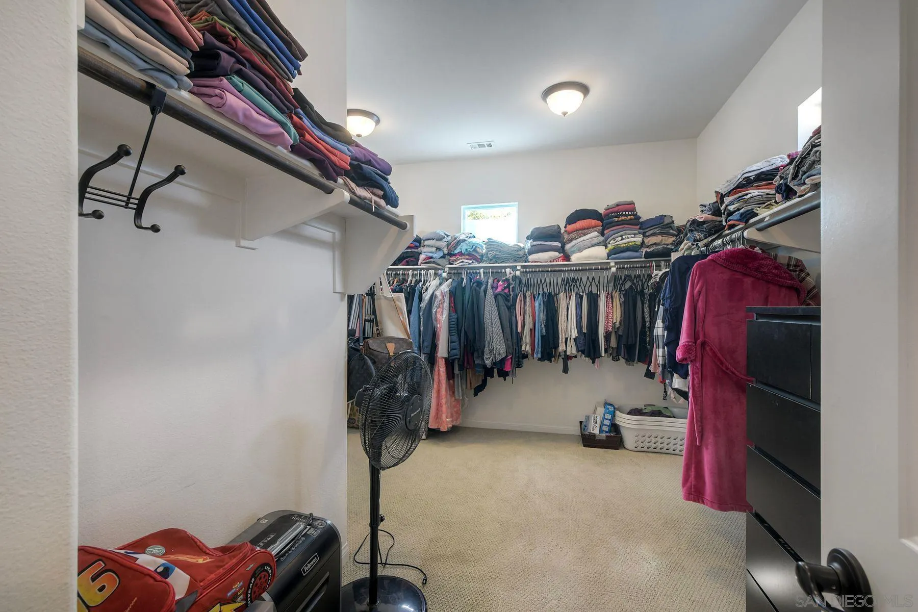 16482 Edgehill Road San Diego, CA 92127 - Photo 32 of 35 a view of walk in closet with clothes and shoes