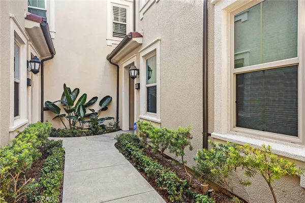 a view of front door of house and potted plants