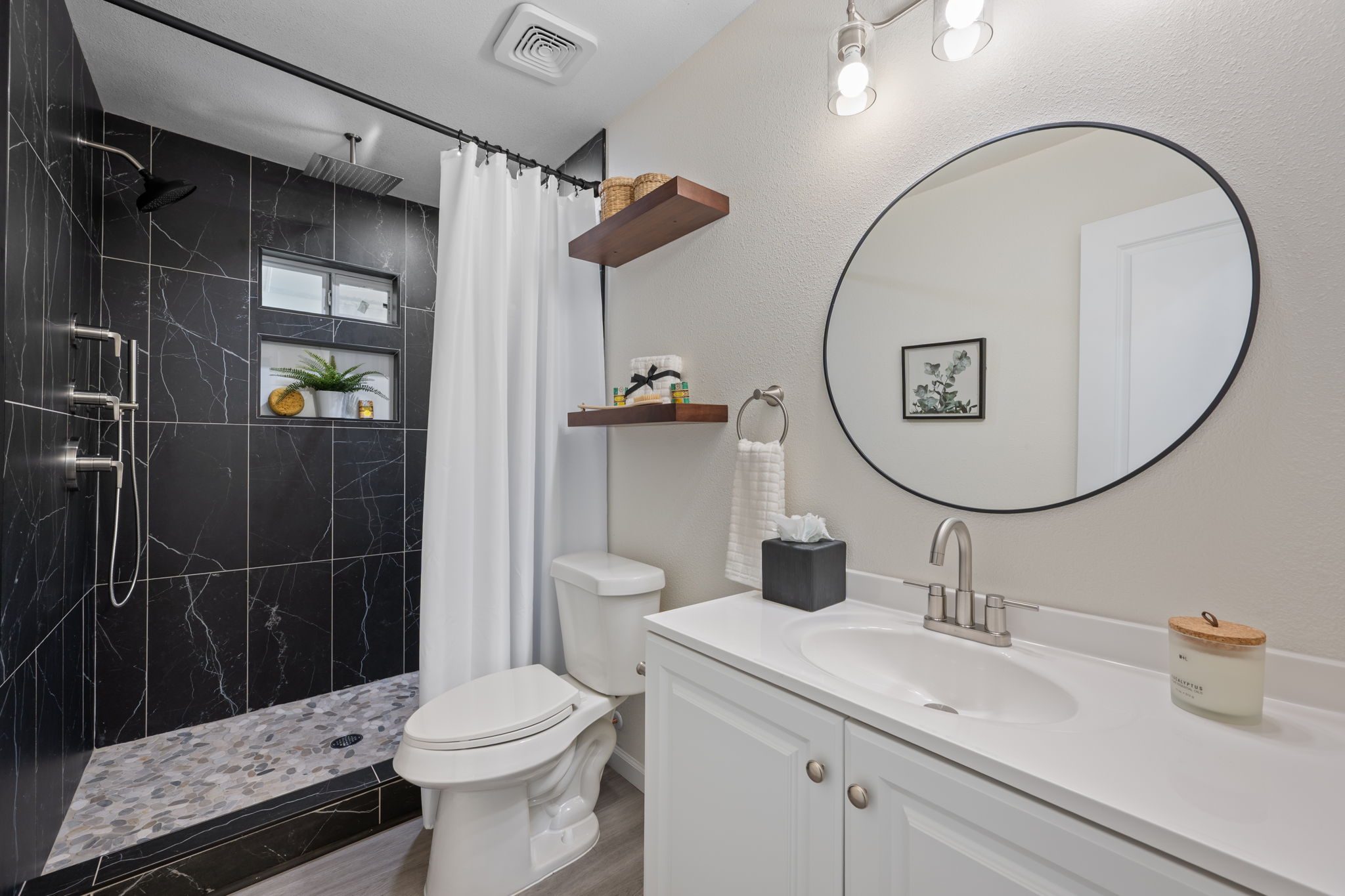 4711 Bandera Road Austin, TX 78721 - Photo 12 of 22 a bathroom with a sink a toilet and a mirror