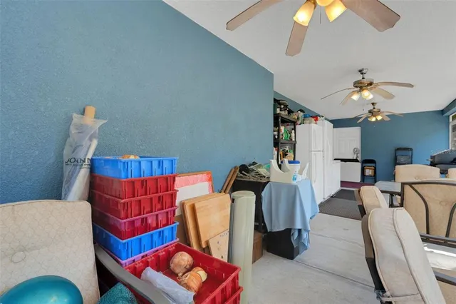 a living room with furniture a chandelier and a mirror