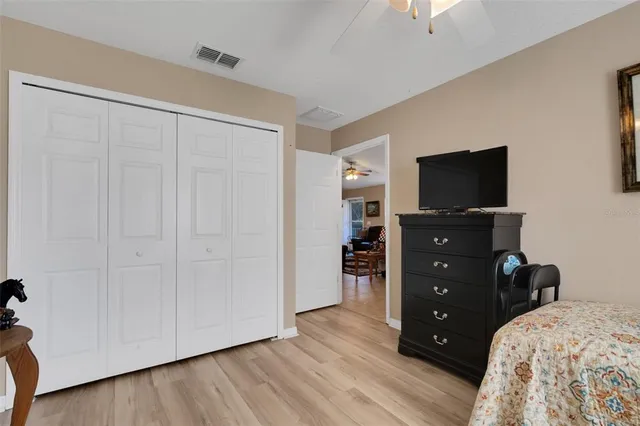 a bedroom with a bed and a television