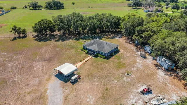 an aerial view of a house with a yard and lake view