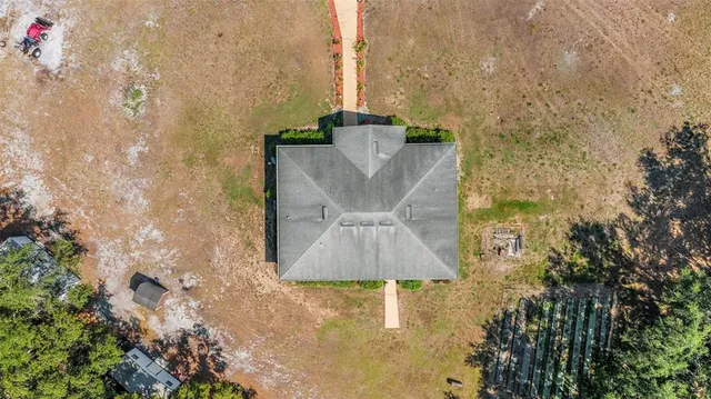 a aerial view of a residential apartment building with swimming pool and large trees