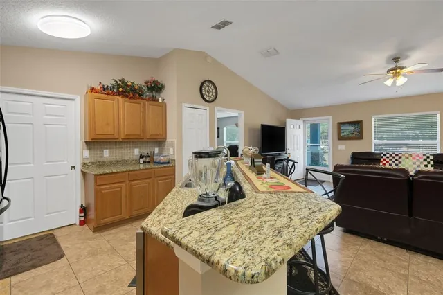 a living room with granite countertop furniture and fireplace