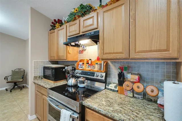 a kitchen with stove and cabinets