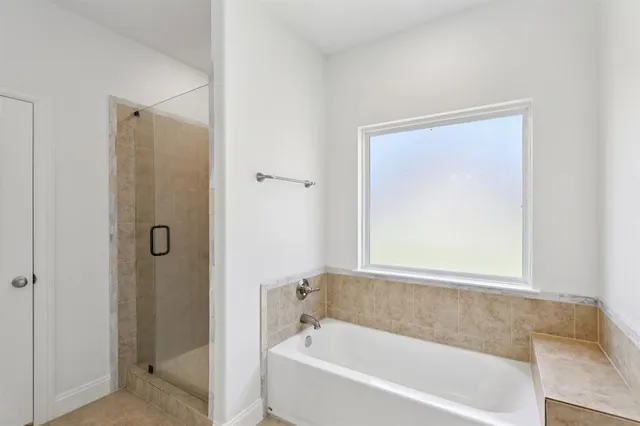a white bath tub sitting next to a shower