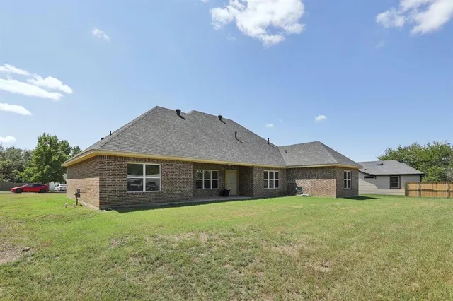 a front view of a house with a garden and yard