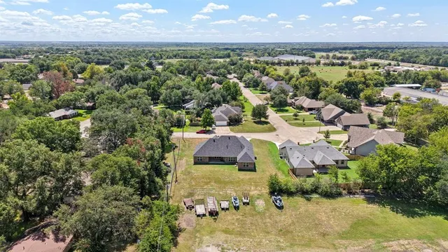 an aerial view of a house with a lake view