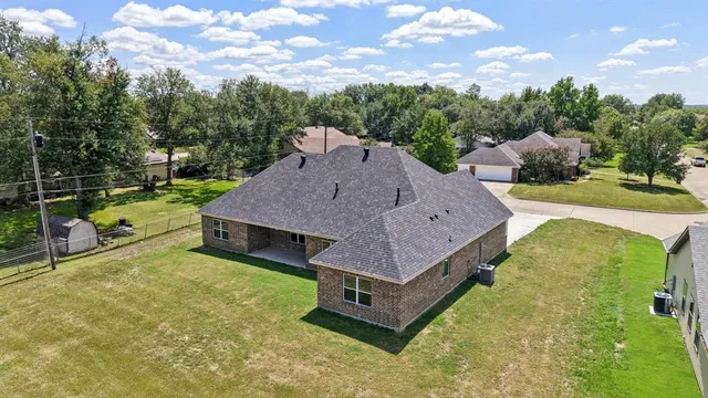 a aerial view of a house with swimming pool and large trees