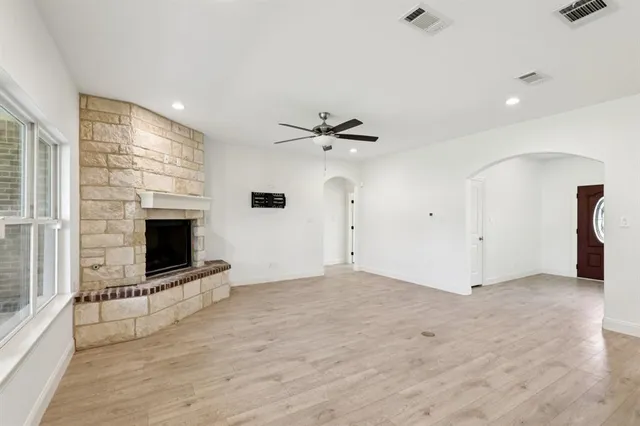 wooden floor in an empty room with a fireplace