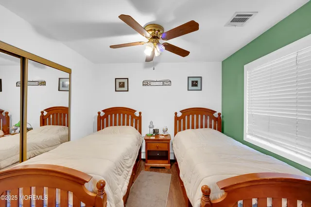 a bedroom with two beds and painting on the wall