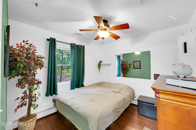 a bedroom with a bed and a potted plant