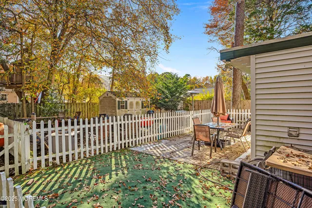 a view of a patio with a table and chairs