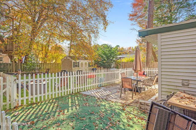 a view of a patio with a table and chairs