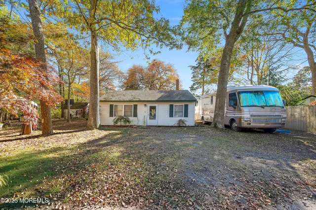 a view of a house with a large tree in front of a house