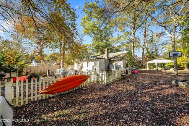 a backyard of a house with table and chairs