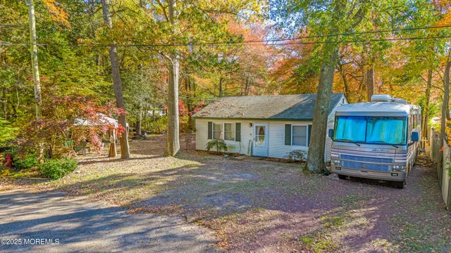 a view of a house with a yard and tree s