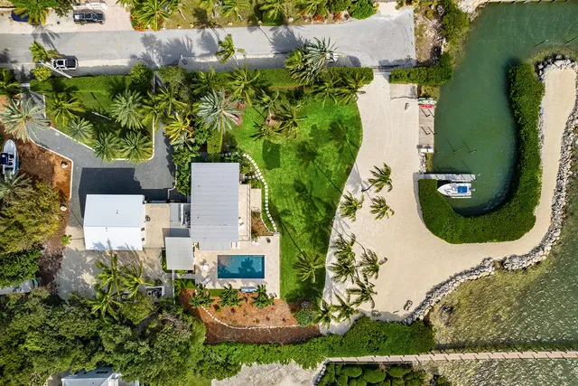 an aerial view of a house with outdoor space pool seating area and yard