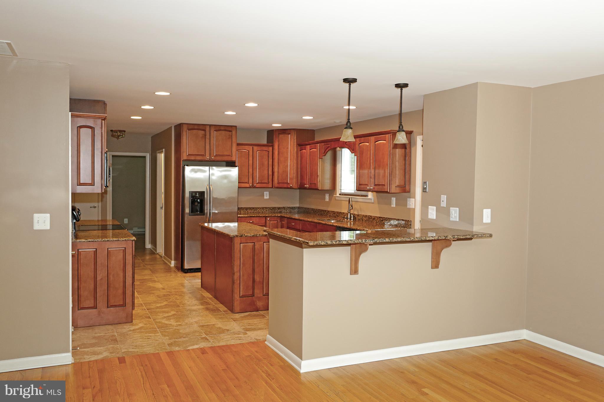 1213 Watervale Road Fallston, MD 21047 - Photo 11 of 30 a kitchen with stainless steel appliances granite countertop a sink a stove and a wooden floors