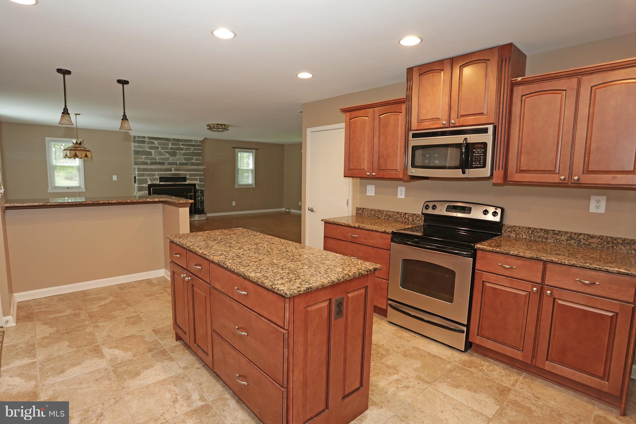 1213 Watervale Road Fallston, MD 21047 - Photo 12 of 30 a kitchen with stainless steel appliances granite countertop a stove a sink and a microwave