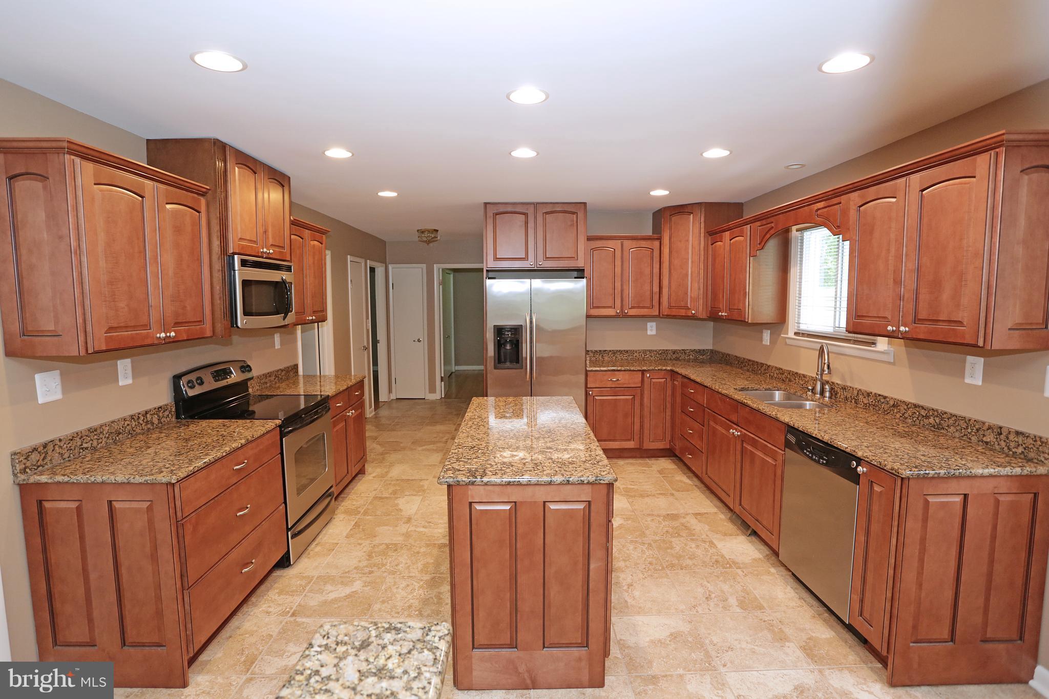 1213 Watervale Road Fallston, MD 21047 - Photo 14 of 30 a large kitchen with stainless steel appliances granite countertop wooden cabinets a stove top oven a granite counter space and a sink