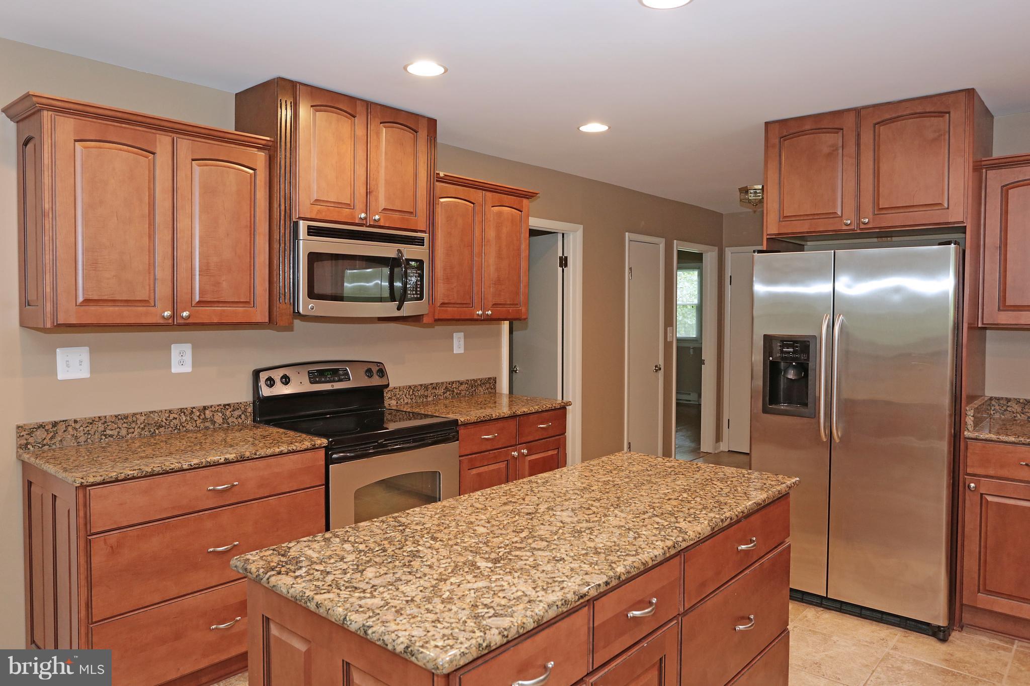 1213 Watervale Road Fallston, MD 21047 - Photo 16 of 30 a kitchen with stainless steel appliances granite countertop a stove refrigerator sink and microwave