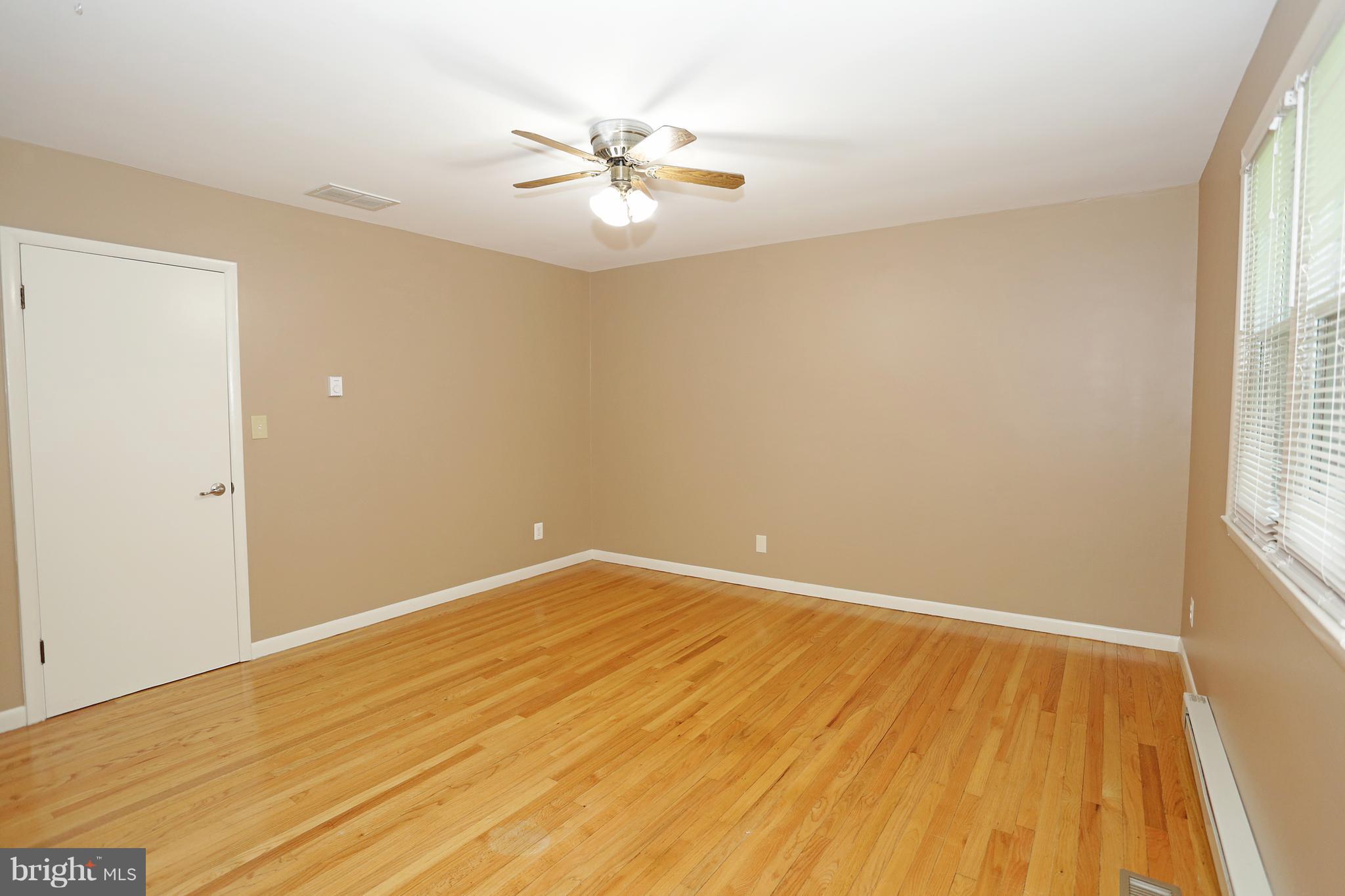 1213 Watervale Road Fallston, MD 21047 - Photo 20 of 30 an empty room with wooden floor and windows